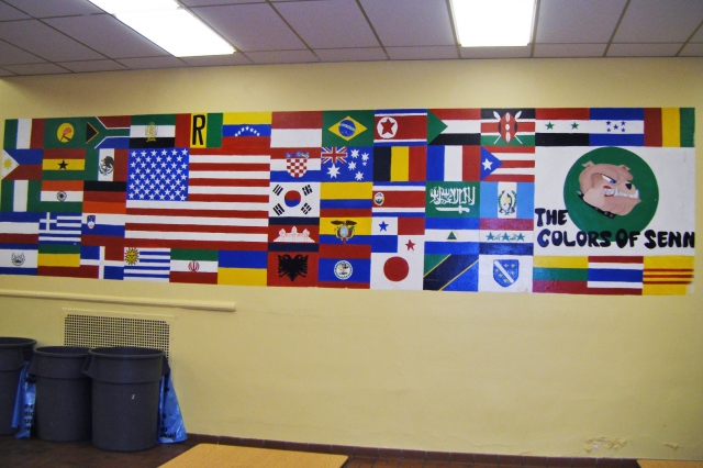 A mural depicting the flags of the countries of origin of current students.