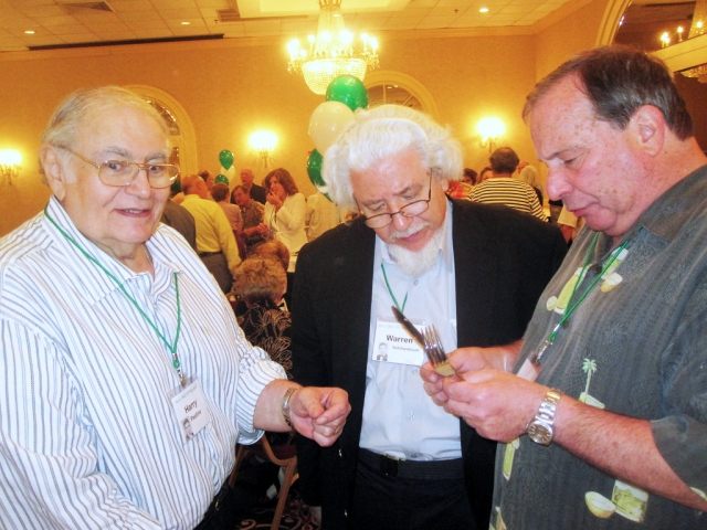 Harry Pestine stands by as Warren Volchenboum and Marty Taxe ponder the hotel silverware.