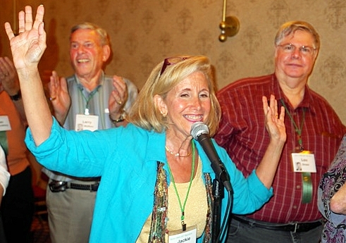 Reunion committee coordinator Jackie Stern waves as she welcomes the assembled classmates on Friday night.  Larry Wolfson and Lou Gross are behind her.